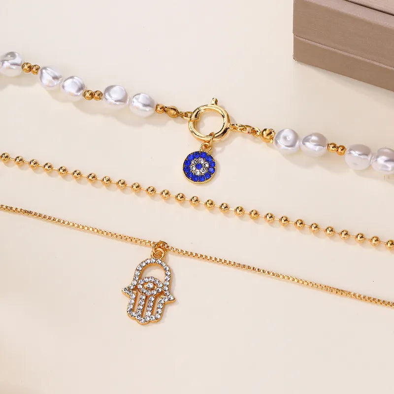 Gold Layered Hamsa Hand & Evil Eye Pearl Necklace Set
